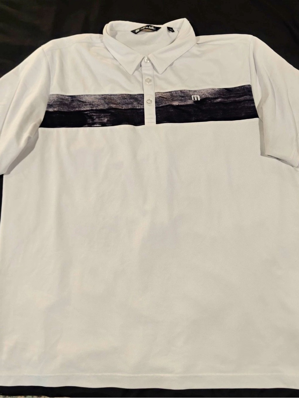 Travis Mathew White Polo with Black Chest Stripe